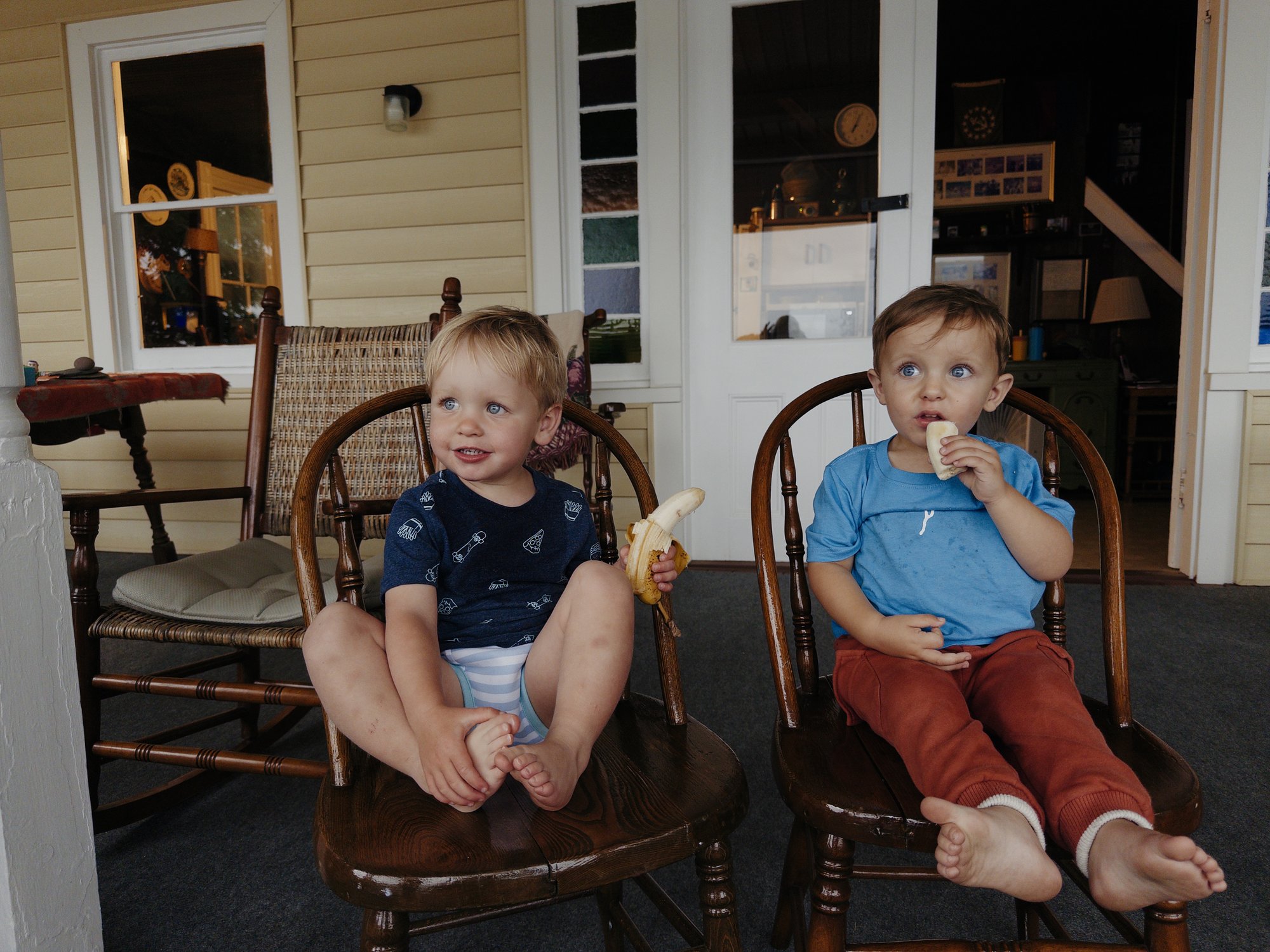 Rory and Brooks sharing a banana on the porch